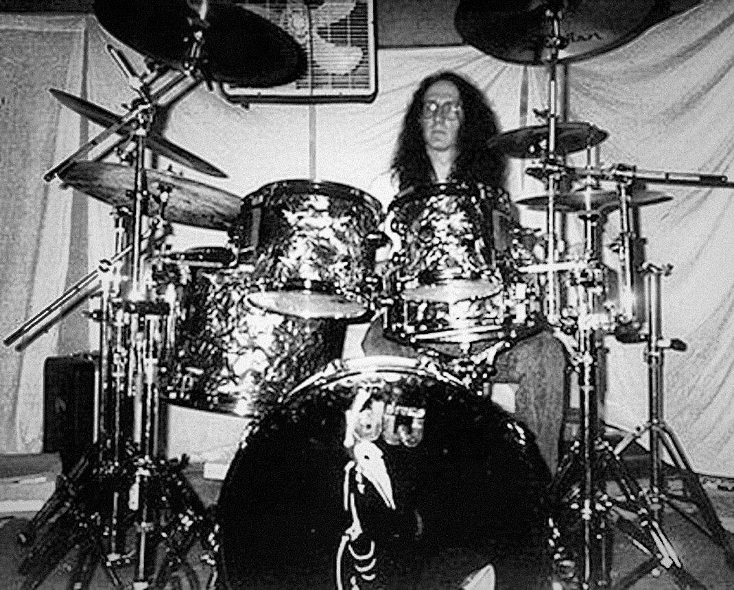 Matt Boudreau, 22, behind a black pearl drum kit at a Sextants rehearsal.