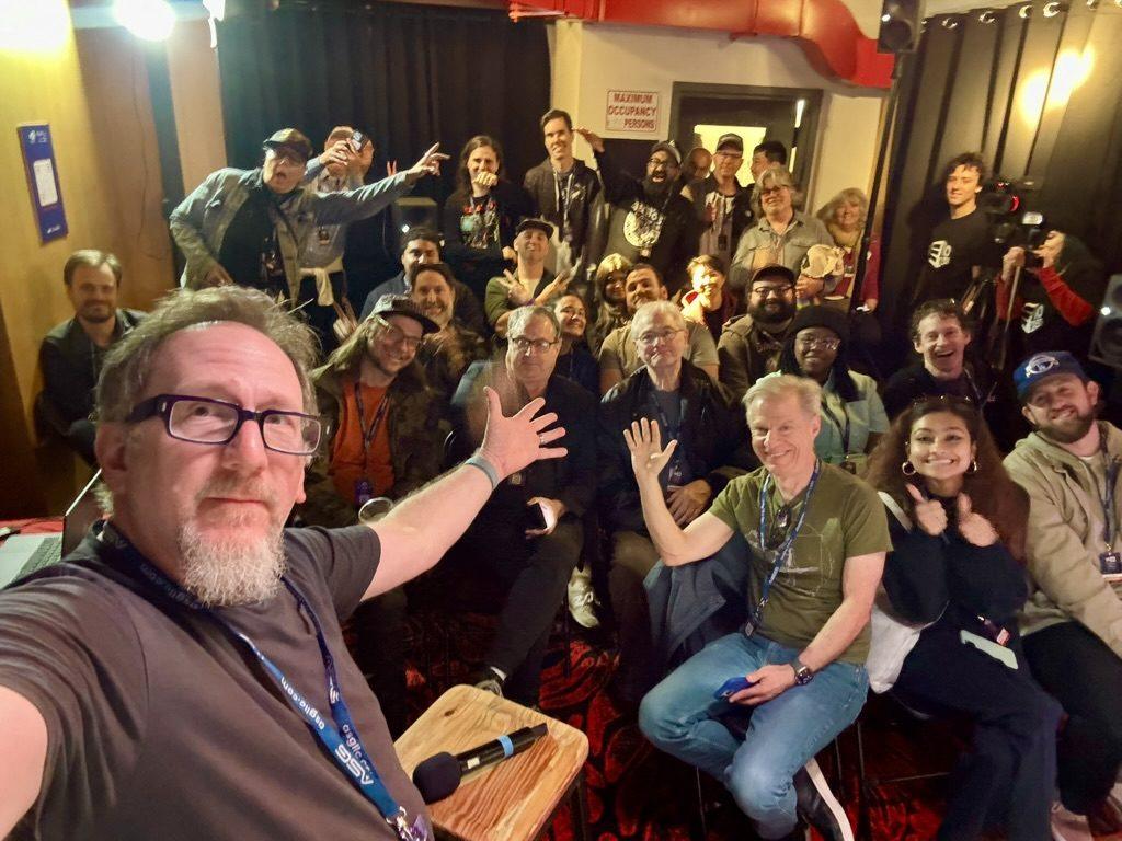 Matt Boudreau taking a selfie with a packed room after his Atmos presentation at Music Expo.