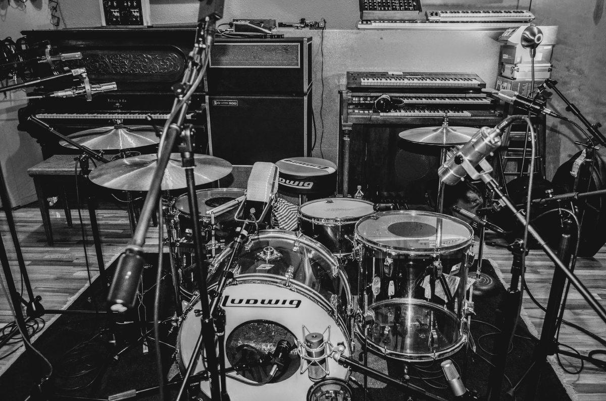 A vintage Ludwig drum kit miked up in the live room at Jackpot in Portland, with piano, organ and amps behind it.