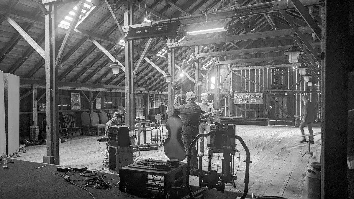A band recording live in a barn for the OneMic series.