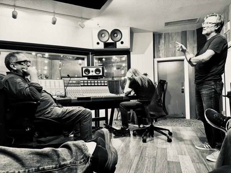 A session at Sharkbite Studios. Matt Boudreau seated at the console, drummer Ihor Pacholuk standing and making a point.